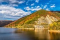 Autumn colored forest reflecting to lake water in Transylvanian Alps Royalty Free Stock Photo