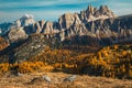 Autumn colorful larch forest and spectacular mountains in background, Dolomites