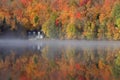Autumn colors and fog reflections on the lake, Quebec, Canada Royalty Free Stock Photo