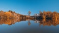 Autumn Colors Forest Woods Yellow Orange Reflecting on Blue Water Lake Landscape Natural Clear Weather Beautiful Royalty Free Stock Photo