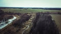 High angle view of a spiraling river and fields in background