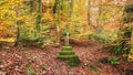 Stone memorial cross in Hacking wood.