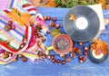 Autumn composition of ceramic cup of herbal tea and vintage vinyl records on aged wooden background with bright handmade crocheted Royalty Free Stock Photo