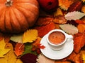 Autumn composition: cup of coffee, colorful autumn leaves and pumpkins. Creative autumn thanksgiving, fall concept