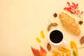 Autumn composition. Cup of coffee, gift, dried autumn leaves, croissant on white background. Flat lay, top view, copy space Royalty Free Stock Photo