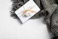 Autumn composition. Feminine desk table with knitted scarf and gift box on white background. Flat lay, top view. Nordic, hygge, Royalty Free Stock Photo
