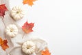 Autumn composition. Flat lay, top view maple leaves, pumpkin, beige fabric on white table. Season background. Autumn fall, Royalty Free Stock Photo