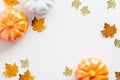 Autumn composition. Frame made of orange pumpkins and maple leaves decorations on white background. Flat lay, top view, overhead Royalty Free Stock Photo