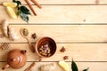 Autumn composition with fruit tea cup, teapot, autumn leaves, cinnamon sticks, anise star, spoon of dried team, lemon, ginger root Royalty Free Stock Photo