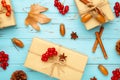Autumn composition and gifts on blue background. Pattern made of autumn leaves, acorn, pine cones