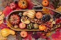 Autumn composition of autumn leaves, colorful pumpkins and apples. Top view, wooden background Royalty Free Stock Photo