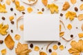 Autumn composition with paper blank and dried leaves on table. Flat lay, top view, copy space Royalty Free Stock Photo