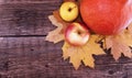 Autumn composition with pumpkin, yellow maple leaves and apple o