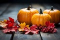 Autumn composition of pumpkins and maple leaves on wooden background. Generative AI Royalty Free Stock Photo