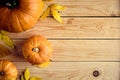 Autumn composition. Pumpkins and yellow leaves on wooden desk.Thanksgiving day or seasonal background. Flat lay, top view, copy Royalty Free Stock Photo