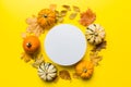 Autumn composition with round paper blank and dried leaves with pumpkin on table. Flat lay, top view, copy space Royalty Free Stock Photo