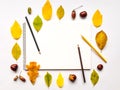 Autumn composition with sketchbook and pencils, decorated with yellow and green leaves. Flat lay, top view Royalty Free Stock Photo