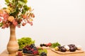 Autumn composition vase, berries, fruits, vegetables on the table in the kitchen