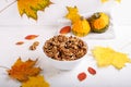 Autumn composition with walnuts, pumpkins and colorful fall leaves on white background. Copy space. Autumn mood, fall season