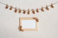 Autumn composition with wooden frame. Acorn with clothespins on clothes line rope. Wooden pegs. Flat lay, top view, copy space. Royalty Free Stock Photo