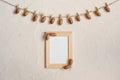 Autumn composition with wooden frame. Acorn with clothespins on clothes line rope. Wooden pegs. Flat lay, top view, copy space. Royalty Free Stock Photo