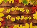 Autumn concept - inscription Hello autumn on yellow maple leaves on a wooden background. Royalty Free Stock Photo