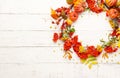 Autumn concept with pumpkins, flowers, autumn leaves and  rowan berries on a white rustic background. Festive autumn decor, flat Royalty Free Stock Photo