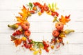 Autumn concept with pumpkins, flowers, autumn leaves and  rowan berries on a white rustic background. Festive autumn decor, flat Royalty Free Stock Photo