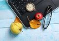 autumn concept, ripe apples, laptop,leaves on blue paint wood surface,top view Royalty Free Stock Photo