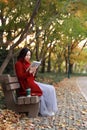 Young asian sensual woman reading a book in romantic autumn scenery.Portrait of pretty young girl in autumnal forest Royalty Free Stock Photo