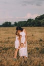 mother small daughter white dresses field straw