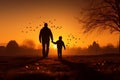 Autumn connection silhouettes of a father and son handinhand at sunset Royalty Free Stock Photo