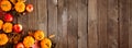 Autumn corner border with pumpkins, leaves and apples over a rustic dark wood background Royalty Free Stock Photo
