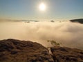 Autumn country. Deep misty valley full of morning heavy wisps of blue orange fog. Sandstone peaks increased from mist, dark hills Royalty Free Stock Photo