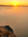 Autumn country. Deep misty valley full of morning heavy wisps of blue orange fog. Sandstone peaks increased from mist, dark hills Royalty Free Stock Photo