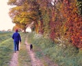 Autumn countryside dog walker Royalty Free Stock Photo