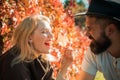 Autumn couple. Happy smiling attractive young couple on date sitting in street cafe in autumn, sharing drink, looking at Royalty Free Stock Photo