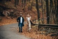 Autumn couple in love walking in the park. Royalty Free Stock Photo