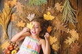 Autumn coziness is just around. Child playful mood hold leaves. Play fall season leisure attributes. Kid cute girl play