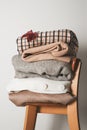 Autumn cozy clothes stack close up on chair