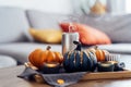 Autumn cozy composition for hygge home decor. Orange and gray pumpkins, just blown out candles with smoke on a tray with Royalty Free Stock Photo