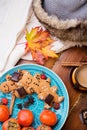 Autumn cozy composition with ripe persimmons and cookies at wooden table. life style concept. flat lay