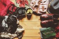 Autumn cozy flat lay with sweater, shoes, vintage camera, backpack and spaniel dog