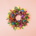 Autumn creative circle decoration made of forest stone fruits.and colorful leaves. Chestnut and nuts flat lay concept on pastel