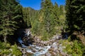 Autumn creek woods with yellow trees foliage and rocks in forest mountain. Royalty Free Stock Photo