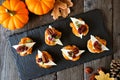 Autumn crostini appetizers with pumpkin spread, cheese and nuts. Table scene.