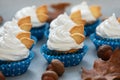 Autumn cupcakes decorated with cream and cookies leaves on gray wooden background. Soft focus. Thanksgiving day or Halloween Royalty Free Stock Photo