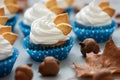 Autumn cupcakes decorated with cream and cookies leaves on gray wooden background. Soft focus. Thanksgiving day or Halloween Royalty Free Stock Photo