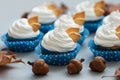 Autumn cupcakes decorated with cream and cookies leaves on gray wooden background. Soft focus. Thanksgiving day or Halloween Royalty Free Stock Photo