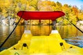Autumn day, boat in the lake in the autumn forest. Yellow leaves of trees are reflected in the waters of the lake Royalty Free Stock Photo
